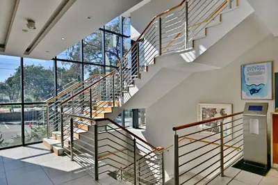 a staircase in a building with glass windows at City Lodge Hotel Waterfall City in Midrand