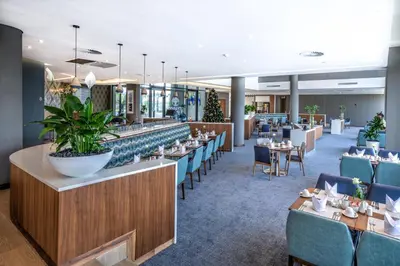 a dining room with tables and chairs at City Lodge Hotel Waterfall City in Midrand