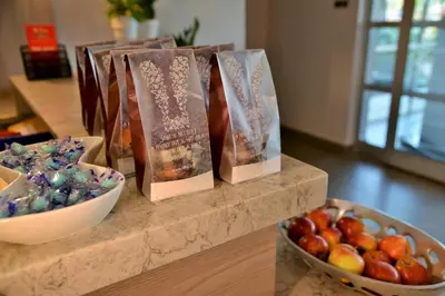 a counter with books and a bowl of apples at Town Lodge Menlo Park in Pretoria