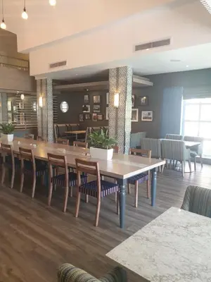 a dining room with a large table and chairs at Town Lodge Menlo Park in Pretoria