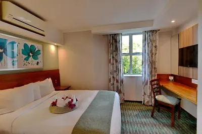 a hotel room with a bed and a window at Town Lodge Waterfall, Midrand in Midrand