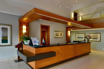 a lobby with a reception desk in a building at Town Lodge Waterfall, Midrand in Midrand