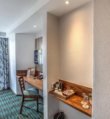 a hotel room with a desk and a chair at Town Lodge Waterfall, Midrand in Midrand