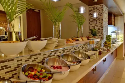 a buffet line with bowls and plates of food at Town Lodge Mbombela in Nelspruit