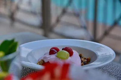 a dessert with whipped cream and berries on a table at Town Lodge Mbombela in Nelspruit