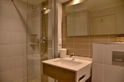 a bathroom with a sink and a shower at Town Lodge Mbombela in Nelspruit