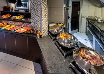 a kitchen with several pans of food on a counter at Town Lodge Polokwane in Polokwane