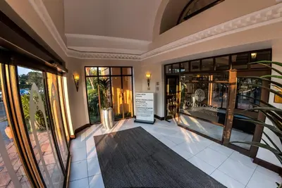 a lobby with a sign in the middle of a building at Town Lodge Polokwane in Polokwane