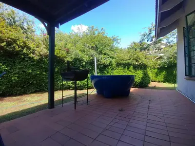 a bath tub sitting on the patio of a house at Kloofsig Holiday Cottages in Graskop