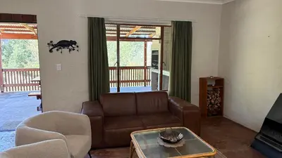 a living room with a couch and a table at The Stix in Dullstroom