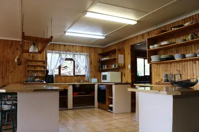 a kitchen with wooden walls and wooden counters at The Stix in Dullstroom