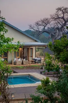 a house with a swimming pool in front of it at Baobab Hill House by RETURN Africa in Makuleke Contract Park