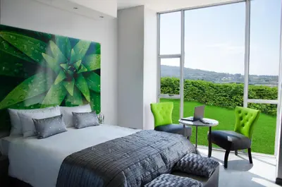 a bedroom with a bed and a large window at Chill Pepper Boutique Hotel in Nelspruit