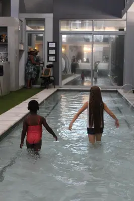 two women are standing in a swimming pool at Chill Pepper Boutique Hotel in Nelspruit