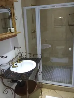 a bathroom with a sink and a shower at J'Cups Guest House in Centurion
