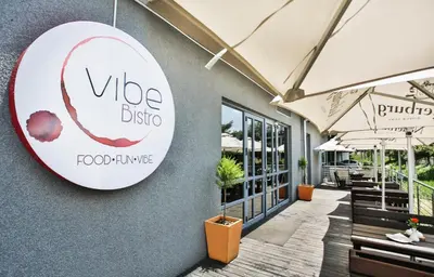 a sign for a vida dining restaurant on the side of a building at Holiday Inn Express Sandton-Woodmead by IHG in Johannesburg