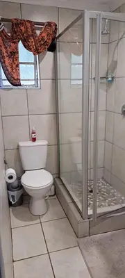 a bathroom with a shower and a toilet at Tarentilos in Tzaneen