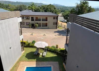 an overhead view of a patio with an umbrella at Nelspruit Lodge in Nelspruit
