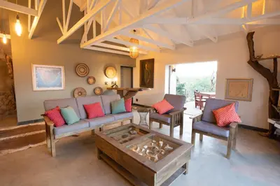 a living room with a couch and chairs and a table at Antares Bush Camp & Umgede Hide in Grietjie Nature Reserve