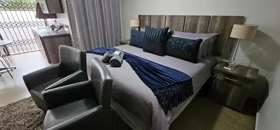 a bedroom with a bed with two stuffed animals on it at Blue Sparrow Guest House in Middelburg