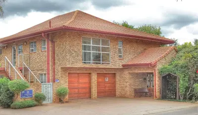a brick house with a garage at The Monte Carlo in Centurion