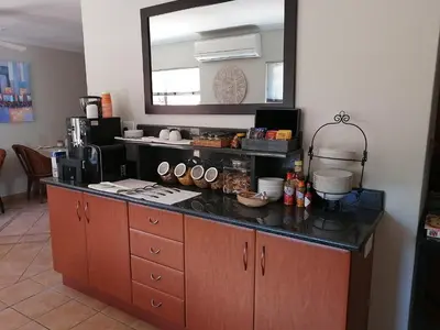 a kitchen with a counter top with a mirror at The Monte Carlo in Centurion
