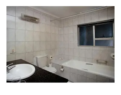 a bathroom with a sink and a tub and a toilet at The Monte Carlo in Centurion