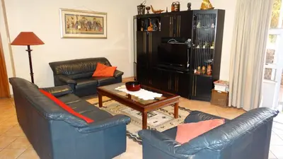 a living room with two couches and a tv at The Monte Carlo in Centurion