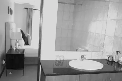 a bathroom with a sink and a mirror at The Monte Carlo in Centurion