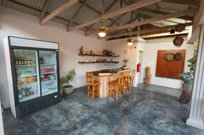 a room with a bar with a table and chairs at The Belgium Inn in Hoedspruit