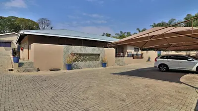 a white car parked in front of a building at Guest House Mamma Mia in Nelspruit