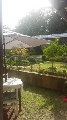 a table with an umbrella in a yard at Guest House Mamma Mia in Nelspruit