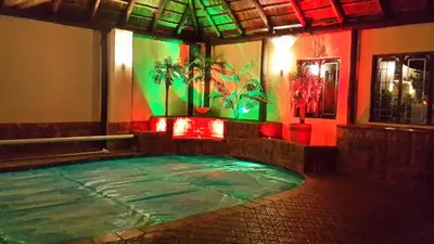 a pool in a room with green and red lights at The Cedars Bed and Breakfast in Centurion