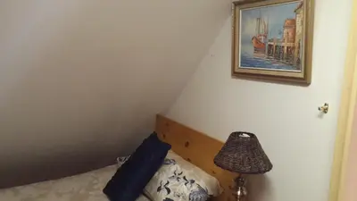 a bedroom with a bed and a picture on the wall at The Cedars Bed and Breakfast in Centurion