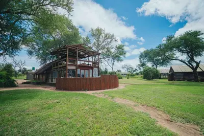 a building in the middle of a field at Buffelshoek Tented Camp in Manyeleti Game Reserve