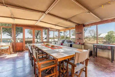 a large dining room with a long table and chairs at Buffelshoek Tented Camp in Manyeleti Game Reserve