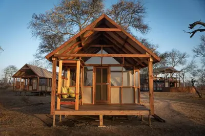 a small house on a wooden stand in a field at Buffelshoek Tented Camp in Manyeleti Game Reserve