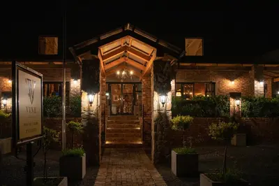 a brick building with lights on it at night at Tarry-Stone Cottages in Dullstroom