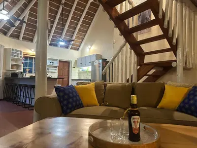 a bottle of wine on a table in a living room at Treetops Marloth Park in Marloth Park