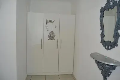 a bathroom with white cabinets and a mirror at Komati Friends in Komatipoort