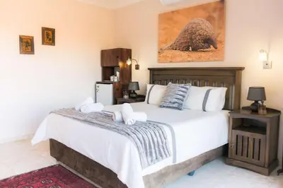 a bedroom with a large bed with towels on it at Mawusi Bush Lodge in Hoedspruit