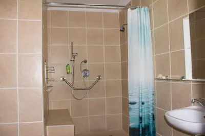 a bathroom with a shower and a sink at Mawusi Bush Lodge in Hoedspruit