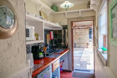a kitchen with a counter and a clock on the wall at Anglers Court in Dullstroom