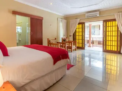 a bedroom with a large bed in a room at Gannet Place Guest House in Hazyview