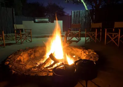a fire pit with pots on it at night at Finfoot Lake Reserve by Dream Resorts in Vaalkop Dam