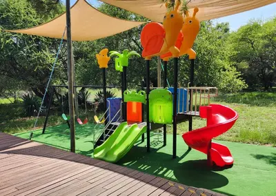 a playground with a slide and a play structure at Finfoot Lake Reserve by Dream Resorts in Vaalkop Dam