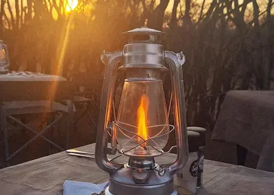 a lantern sitting on top of a table at Finfoot Lake Reserve by Dream Resorts in Vaalkop Dam