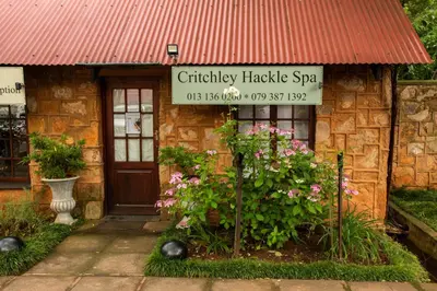 a brick building with a sign in front of it at Critchley Hackle - Managers Cottage in Dullstroom