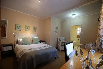 a bedroom with a bed and a mirror in it at Big Tree Midrand in Midrand