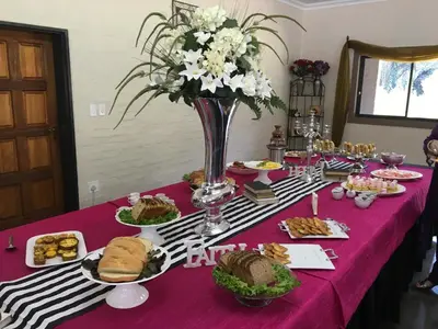 a table with a pink table cloth with food on it at Big Tree Midrand in Midrand